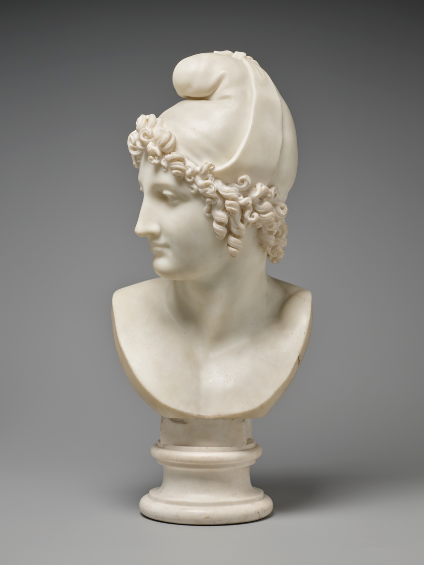Life-sized white marble bust of man with curly hair and strong features.