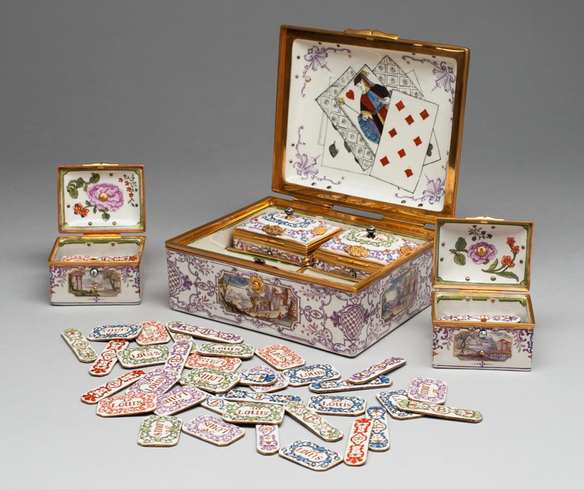 Gilded porcelain box of betting chips for card game.