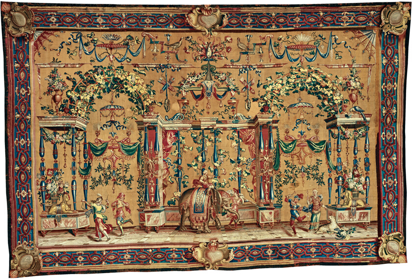 Bordered textile depicting a festive scene on a gold background in yellow, red, green, and blue.