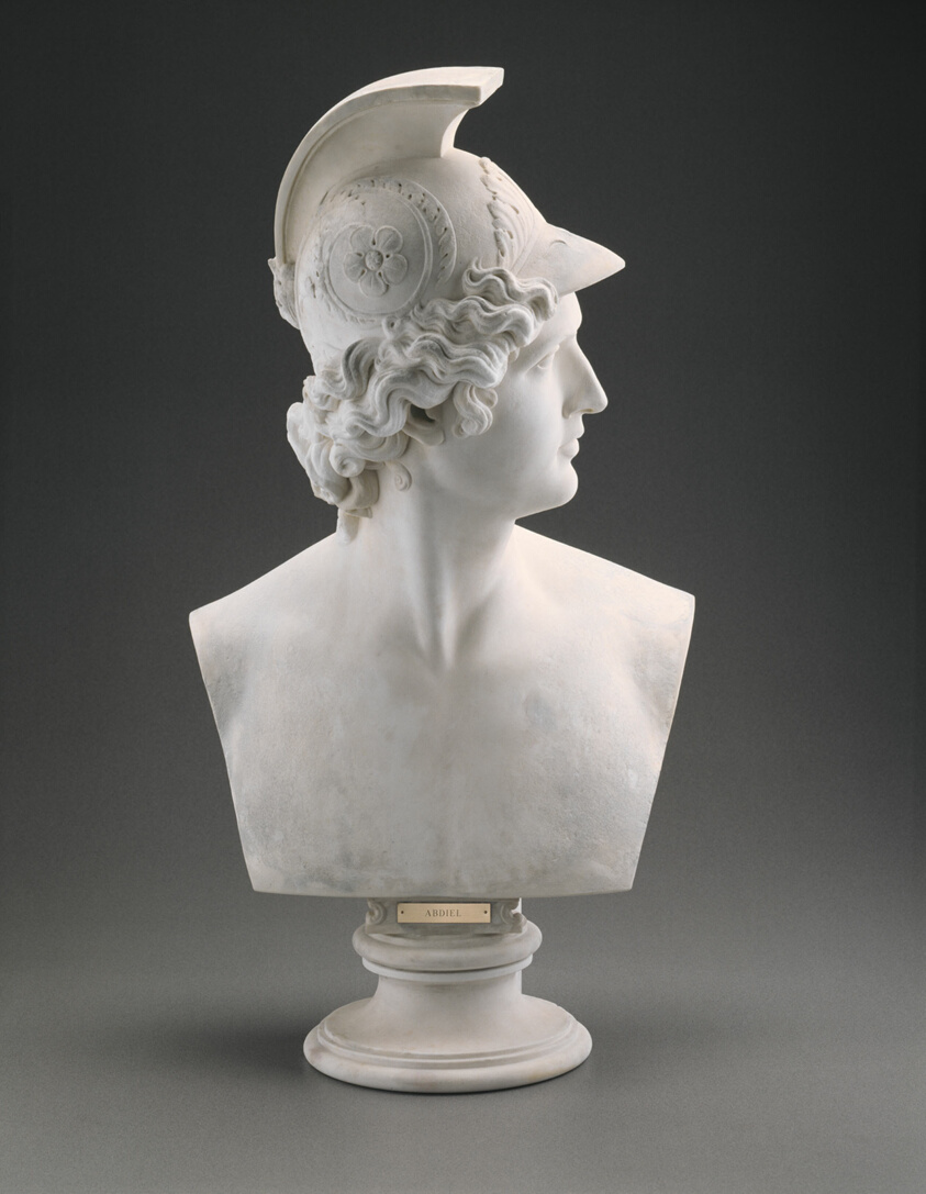 Marble bust of a young man seen in profile with a prominent nose and fine features. He wears an ornate greek warrior's helmet atop wavy locks of hair. At the base is a plate says "Abdiel."