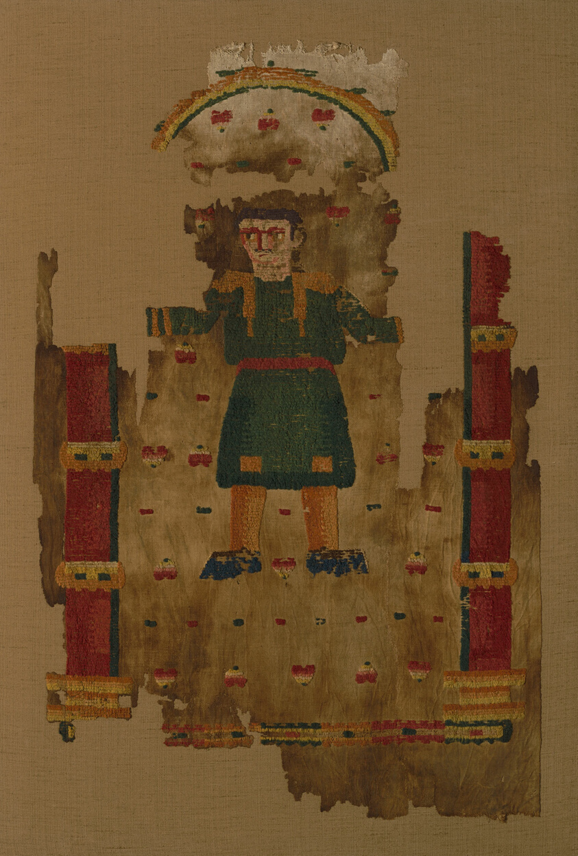 Hanging cloth depicting figure in green cloak under rainbow.